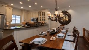 a kitchen and dining room with a wooden table and chairs at Chalet Verve in Beaver Creek
