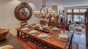 a dining room with a wooden table and a mirror at Chalet Verve in Beaver Creek