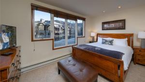 a bedroom with a bed and a large window at Chalet Verve in Beaver Creek