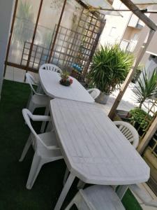 a white picnic table and chairs on a balcony at Bragaterrace in Braga
