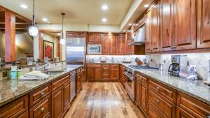 a large kitchen with wooden cabinets and wooden floors at Chalet Veranda in Steamboat Springs