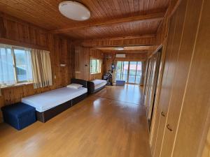 a bedroom with a bed and a couch in a room at Mogamigun - House - Vacation STAY 20251 in Shinjo