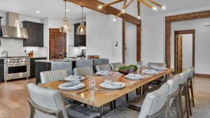 a kitchen and dining room with a wooden table and chairs at Cherrybrook Chalet in Overlook Athletic Club Heliport +32 photos