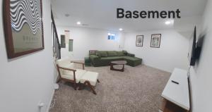 a living room with a green couch and chairs at Auth Townhome in Camp Springs +3 photos