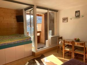 a room with a bed and a table and a window at Studio Vars in Collobrières