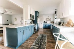 a kitchen with blue cabinets and white counter tops at Lake Park Landing in Atascadero