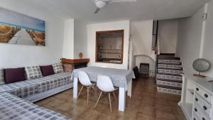 a living room with a table and a couch at Villaparadisi in Benicàssim
