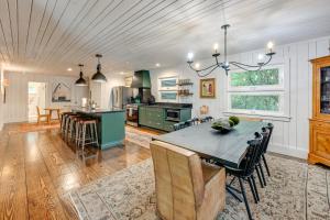 a kitchen with a table and a dining room at Chic Highlands Cabin Retreat with Deck and Office! in Highlands
