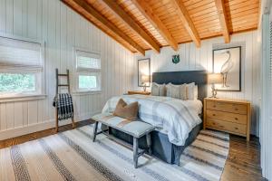a bedroom with a bed and a chair in it at Chic Highlands Cabin Retreat with Deck and Office! in Highlands