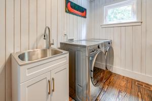 a laundry room with a sink and a washing machine at Chic Highlands Cabin Retreat with Deck and Office! in Highlands +24 photos