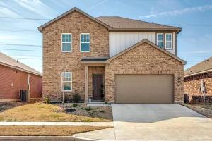 a large brick house with a garage at Fenced Yard • Foosball • Putting Green in Crowley