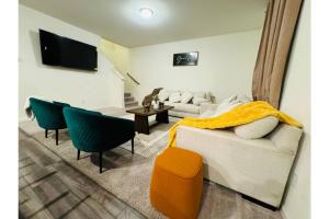 a living room with a couch and a table at Fenced Yard • Foosball • Putting Green in Crowley