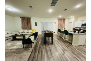a living room with a couch and a table at Fenced Yard • Foosball • Putting Green in Crowley
