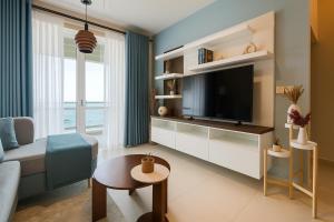 a living room with a television and a couch and a table at Sandora Living in Wattala