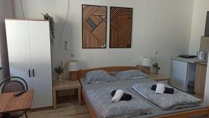 a bedroom with two twin beds and a table at Sunčani apartman - Studio - 3 in Krupanj