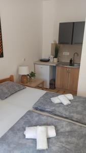 two beds with towels on them in a room at Sunčani apartman - Studio - 3 in Krupanj