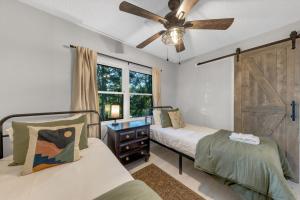 a bedroom with two beds and a ceiling fan at The White Lodge 4BDR Sleeps 8 with Fire Pit in Alcoa