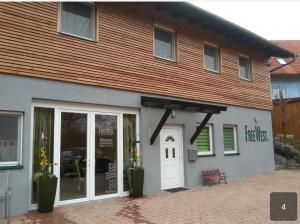 a building with a white door and a sign on it at FreeWest in Pirkhof