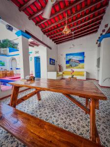 a large wooden table in the middle of a room at The Blue House Hostel Santa Marta in Santa Marta