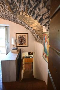 a room with a stone ceiling and a stairway at Antico Casale di Bobbio B&B in Bobbio