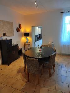 een keuken en eetkamer met een tafel en stoelen bij Maison mignonne in Hirson