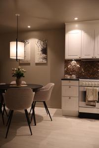 a kitchen with a dining room table and chairs at Arctic City Suites 2 in Kirkenes