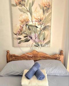 a picture of a flower painting above a bed at Megatower 3 4f29 Baguio Condo by Dei Gratia in Baguio