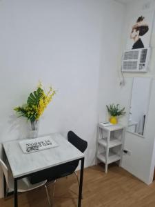 a table and a chair in a room at Bella's Flats in Bayanihan in Pajak