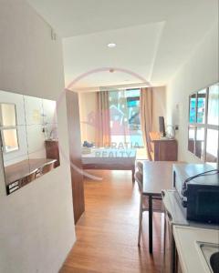 a kitchen with a table and a room with a bed at Megatower 3 4f29 Baguio Condo by Dei Gratia in Baguio