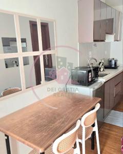 a kitchen with a wooden table and two chairs at Megatower 3 4f29 Baguio Condo by Dei Gratia in Baguio +3 photos