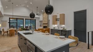 a kitchen with a large island and a living room at Friesian Chalet in Steamboat Springs +16 photos