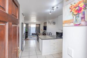 a kitchen with white cabinets and a vase of flowers at Prime Apartments in Richwood