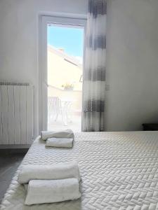 a bedroom with a bed with two towels on it at Eden Home just a few minutes from Lake Maggiore in Gravellona Toce