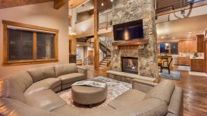 a living room with a couch and a fireplace at Fuerza Grande in Steamboat Springs