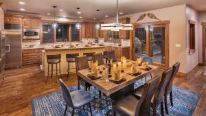 a kitchen with a large wooden table and chairs at Fuerza Grande in Steamboat Springs