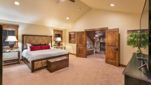 a large bedroom with a bed and a fireplace at Fuerza Grande in Steamboat Springs +45 photos