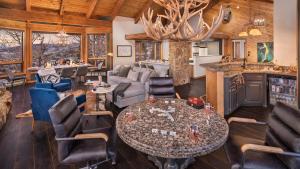 a living room with a table and chairs at Glacier Grande in Steamboat Springs