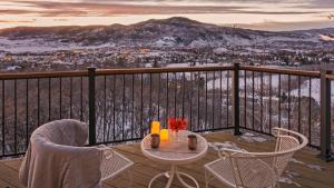 a table and chairs on a balcony with a view at Glacier Grande in Steamboat Springs