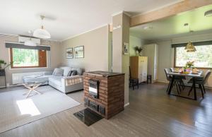 a living room with a couch and a fireplace at Ranua Haistila Retreat with Elegant Views & Sauna near Rovaniemi in Ranua