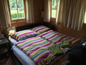 a bed with two pillows on it in a room at Eisenberg Chalet in Eisenberg an der Pinka
