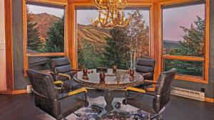a dining room with a table and chairs and a large window at Glacier Lodge - West in Steamboat Springs +21 photos
