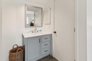 a white bathroom with a sink and a mirror at 1806 Heron Point in Summerville