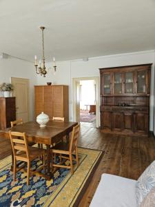 a dining room with a wooden table and chairs at La casa di Mel in Mel