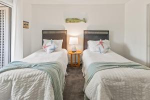 two beds sitting next to each other in a room at 1806 Heron Point in Summerville +28 photos