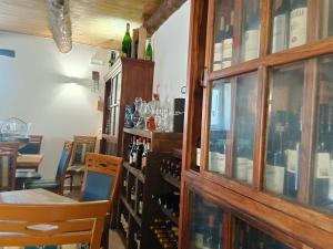 a tasting room with bottles of wine on a wall at Villa Aurea Rooms & More in Papasidero