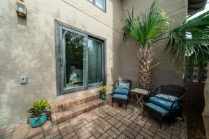 a patio with two chairs and a table and a window at 1905 Bohicket Marina in Seabrook Island