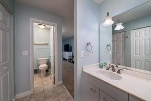 a bathroom with a sink and a toilet and a mirror at 1905 Bohicket Marina in Seabrook Island