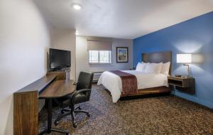 a hotel room with a bed and a desk and a computer at My Place Hotel-Phoenix East Mesa, AZ in Mesa