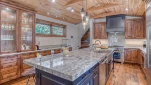 a kitchen with wooden cabinets and a marble counter top at Harris House in Breckenridge
