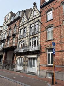 a brick building with windows and balconies on a street at Villa Paul in Blankenberge